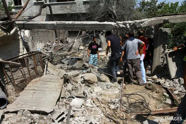 Palestinians inspect damages in Beit Hanun in the northern Gaza Strip on July 17, 2011 as seven people were wounded by what Palestinian medical sources said was an Israeli air strike, but Israel denied it had carried out...