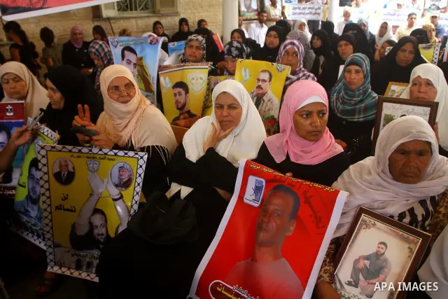 Mothers of Palestinian prisoners held in Israeli jails attend a weekly protest calling for the release of Palestinian prisoners at the International Red Cross building in Gaza City 18 July 2011. It is reported that about...