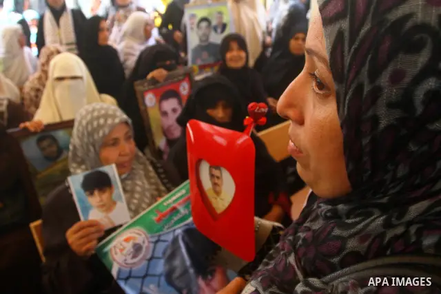Mothers of Palestinian prisoners held in Israeli jails attend a weekly protest calling for the release of Palestinian prisoners at the International Red Cross building in Gaza City 18 July 2011. It is reported that about...