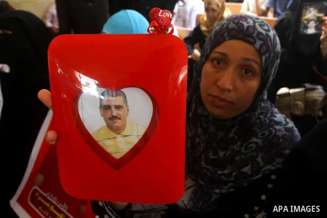 Mothers of Palestinian prisoners held in Israeli jails attend a weekly protest calling for the release of Palestinian prisoners at the International Red Cross building in Gaza City 18 July 2011. It is reported that about...