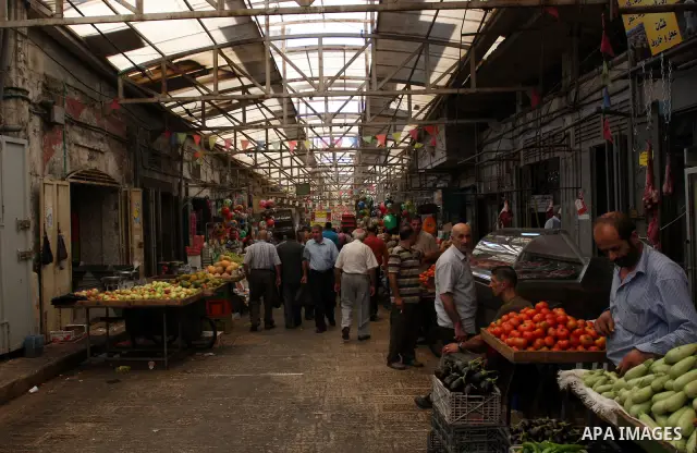Palestinians buy vegetables in the market of the Old City of Nablus in the West Bank on July 18, 2011. Photo by Wagdi Eshtayah