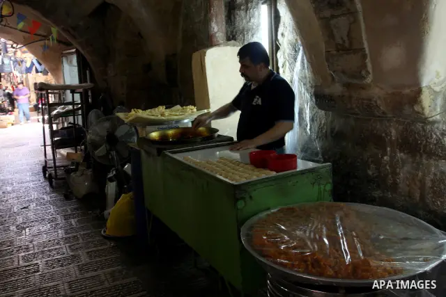 A Palestinian vendor traditional sweets in the Old City of Nablus in the West Bank on July 18, 2011 . Photo by Wagdi Eshtayah