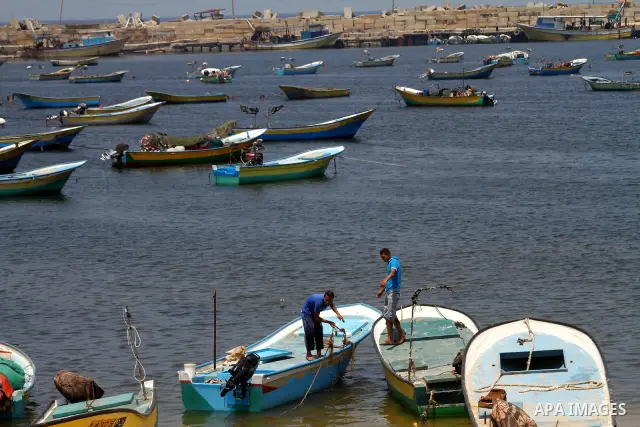 Palestinian fishermen ride a boat at the Gaza seaport on July 19, 2011. The Israeli navy on Tuesday boarded a French yacht carrying pro-Palestinian activists intending to sail to the blockaded Gaza Strip and forced it to...