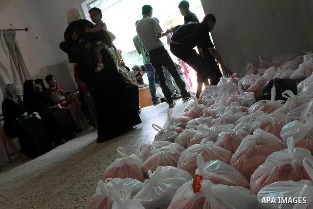 Palestinians receive donated food from an Islamic charity at a Palestinian hospice in Gaza city on July 19,2011. Photo by Mohammed Asad