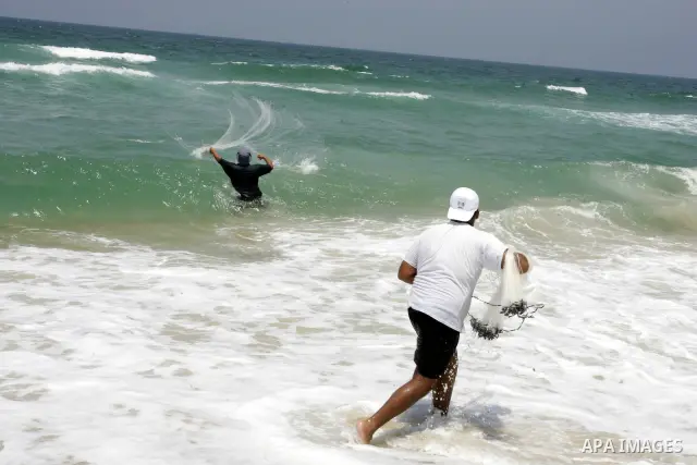 A Palestinian man fishes at Rafah beach in the southern Gaza Strip on July 19, 2011. Israeli naval commandos on Tuesday seized control of a French ship attempting to break Israel's blockade of the Gaza Strip, reporting n...