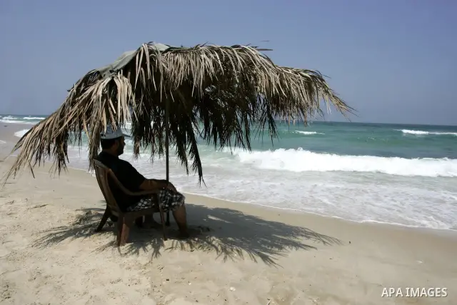 A Palestinian man sits at Rafah beach in the southern Gaza Strip on July 19, 2011. Israeli naval commandos on Tuesday seized control of a French ship attempting to break Israel's blockade of the Gaza Strip, reporting no...