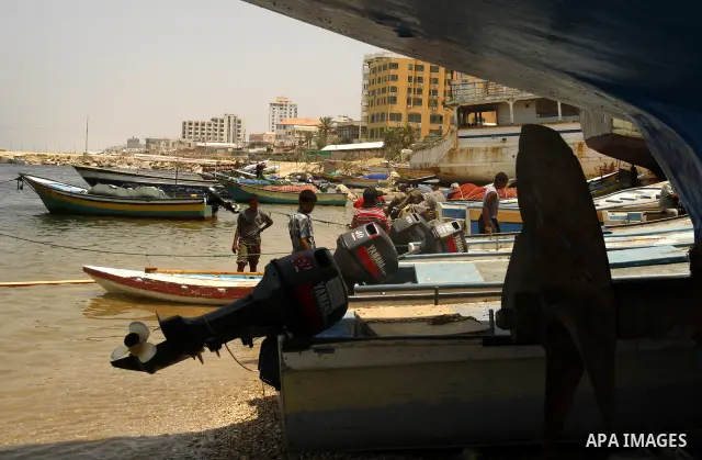 Palestinian children ride a boat at Gaza city port on July 19, 2011. Israeli naval commandos on Tuesday seized control of a French ship attempting to break Israel's blockade of the Gaza Strip, reporting no resistance dur...