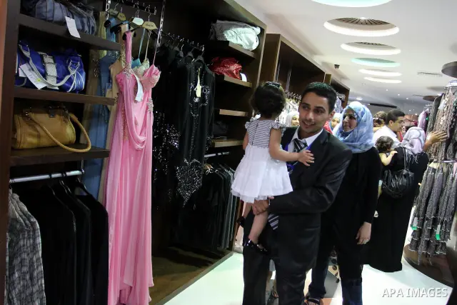 Palestinian shoppers crowd the inside of the shopping mall's new 'Andalusia'. Everything from household goods and food to clothing and shoes are available at the new shopping location in Gaza city on July 19, 2011 . Phot...