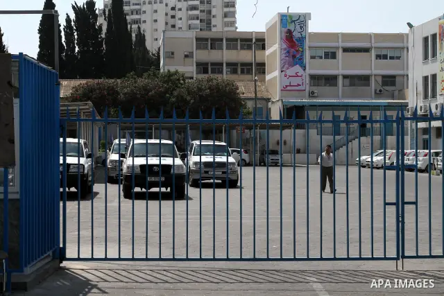 Palestinians close the gates of the UNRWA headquarters in Gaza against the UNRWA decision to change its name in Gaza city on July 20, 2011. Photo by Mohammed Asad