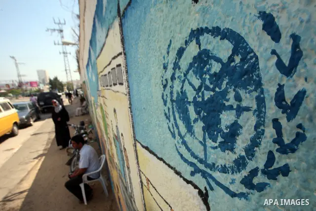 A Palestinian man sits infront of the UNRWA headquarters during a protest against the UNRWA decision to change its name in Gaza city on July 20, 2011. Photo by Ali Jadallah