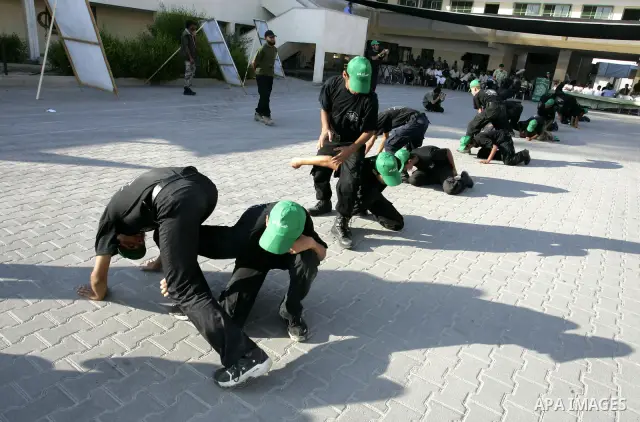 Palestinian youths parade with wooden weapons at a Hamas-run summer camp in Rafah, southern Gaza Strip, on July 20, 2011. The Islamist movement Hamas is holding summer camps throughout the Gaza Strip, where participants...