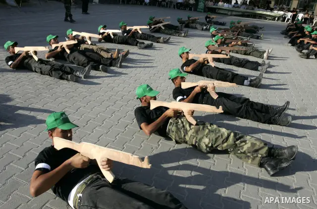 Palestinian youths parade with wooden weapons at a Hamas-run summer camp in Rafah, southern Gaza Strip, on July 20, 2011. The Islamist movement Hamas is holding summer camps throughout the Gaza Strip, where participants...
