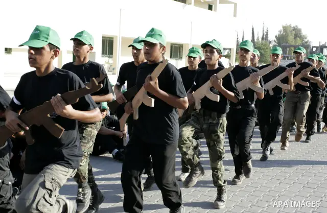 Palestinian youths parade with wooden weapons at a Hamas-run summer camp in Rafah, southern Gaza Strip, on July 20, 2011. The Islamist movement Hamas is holding summer camps throughout the Gaza Strip, where participants...