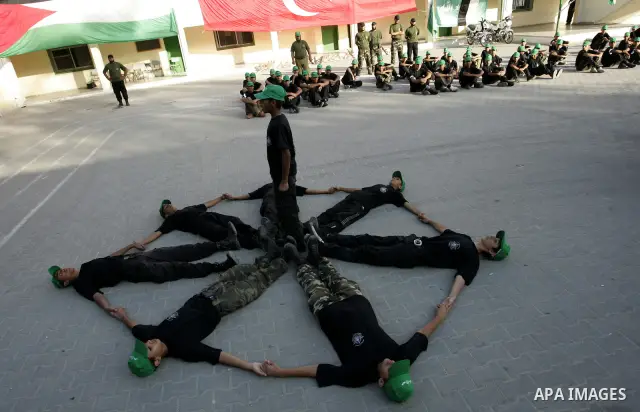 Palestinian youths parade with wooden weapons at a Hamas-run summer camp in Rafah, southern Gaza Strip, on July 20, 2011. The Islamist movement Hamas is holding summer camps throughout the Gaza Strip, where participants...