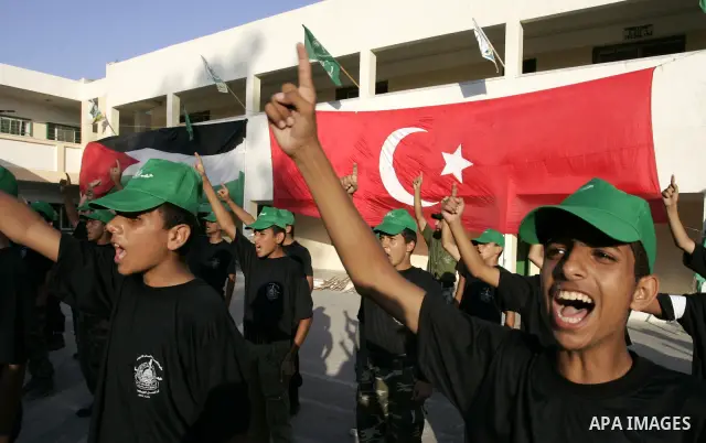 Palestinian youths parade with wooden weapons at a Hamas-run summer camp in Rafah, southern Gaza Strip, on July 20, 2011. The Islamist movement Hamas is holding summer camps throughout the Gaza Strip, where participants...