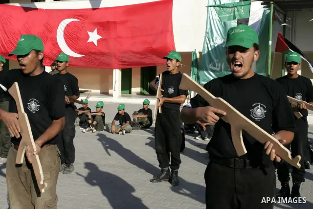 Palestinian youths parade with wooden weapons at a Hamas-run summer camp in Rafah, southern Gaza Strip, on July 20, 2011. The Islamist movement Hamas is holding summer camps throughout the Gaza Strip, where participants...