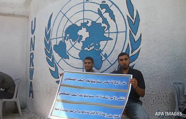 Palestinians take part during a protest infront of the UNRWA headquarters against the UNRWA decision to change its name and Reduce aid in Gaza city on July 21, 2011. Photo by Ashraf Amra