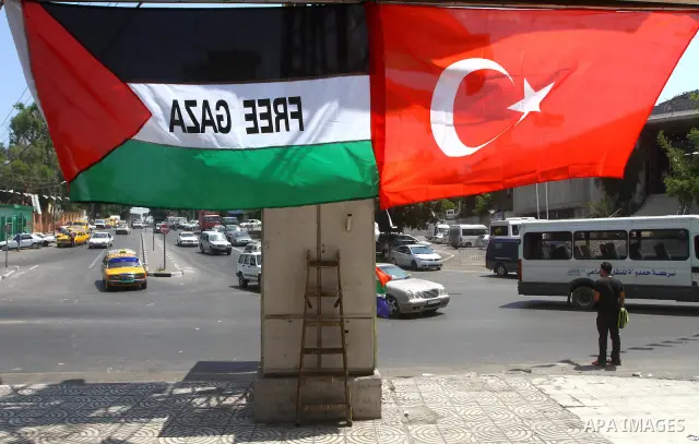Palestinians comment the Palestinian national flag and the turkish flag in the streets in Gaza City on July 21, 2011 following Erdogan's statement that he was considering visiting the Hamas-run Gaza Strip, a move likely...