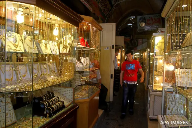 A Palestinian man walks in a jewellery market in Gaza city on 21 July 2011. A Palestinian vendor says that the one gold ounce cost 1650 US dollars at the local market which is and all time high for the market. Photo by A...