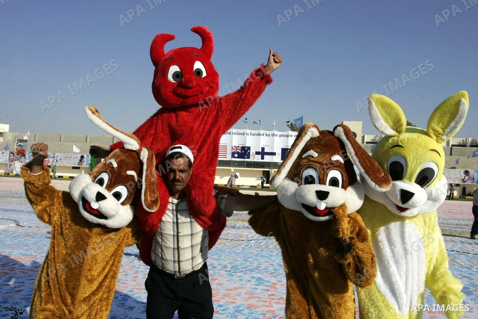 Palestinian children attend an event organised by the the United Nations Relief and Works Agency (UNRWA) in which they attempt to break the Guinness world record for the largest hand-print paint in Khan Yunis, southern G...