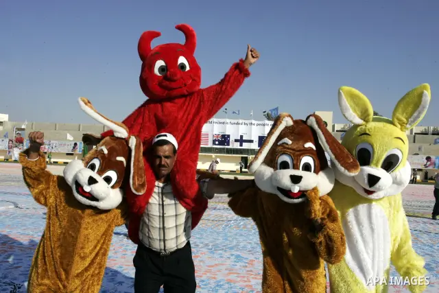 Palestinian children attend an event organised by the the United Nations Relief and Works Agency (UNRWA) in which they attempt to break the Guinness world record for the largest hand-print paint in Khan Yunis, southern G...