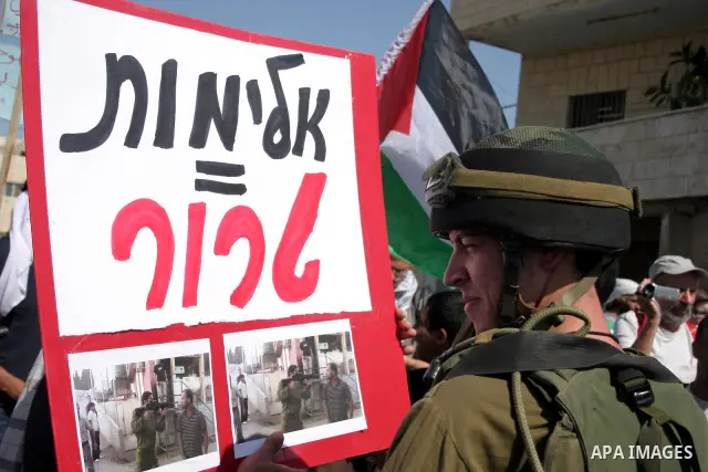 An Israeli soldier scuffles with a protester during a demonstration by Palestinian, Israeli, and foreign protesters in the West Bank village of Beit Omar, near Hebron Friday, July 22, 2011. The demonstration concerned a...