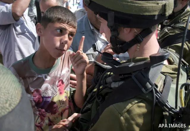 An Israeli soldier scuffles with a protester during a demonstration by Palestinian, Israeli, and foreign protesters in the West Bank village of Beit Omar, near Hebron Friday, July 22, 2011. The demonstration concerned a...