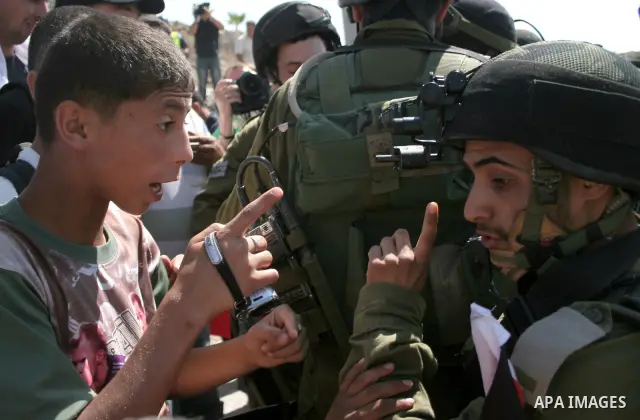 An Israeli soldier scuffles with a protester during a demonstration by Palestinian, Israeli, and foreign protesters in the West Bank village of Beit Omar, near Hebron Friday, July 22, 2011. The demonstration concerned a...