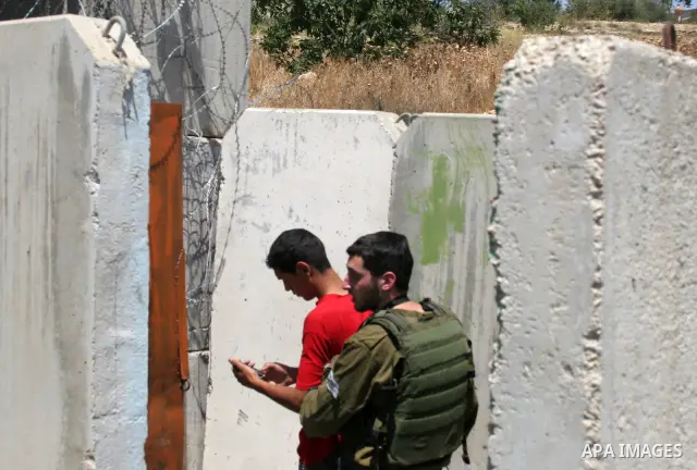 An Israeli soldier detains a protester during a demonstration by Palestinian, Israeli, and foreign protesters in the West Bank village of Beit Omar, near Hebron Friday, July 22, 2011. The demonstration concerned a recent...