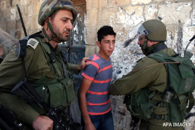 Israeli soldiers detain a protester during clashes with Palestinian protesters from the West Bank village of Nabi Saleh, north of Ramallah, on July 22, 2011 during a weekly Friday protest against Israeli West Bank settle...