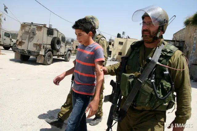 Israeli soldiers detain a protester during clashes with Palestinian protesters from the West Bank village of Nabi Saleh, north of Ramallah, on July 22, 2011 during a weekly Friday protest against Israeli West Bank settle...
