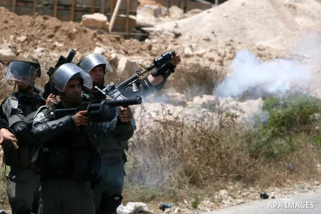 Israeli soldiers fire tear gas grenades during clashes with Palestinian protesters from the West Bank village of Nabi Saleh, north of Ramallah, on July 22, 2011 during a weekly Friday protest against Israeli West Bank se...