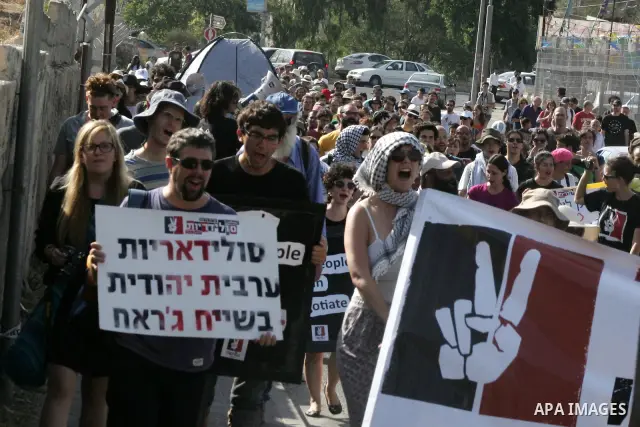 Palestinians, Israelis and foreign activists take part in a weekly demonstration in solidarity with the people of the Sheikh Jarrah neighbourhood who are being expelled from their homes in Jerusalem on July 22,2011. Phot...