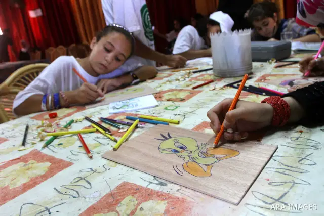 Palestinian girls enjoy at a summer camp and performing handicrafts in Gaza City on July 23, 2011. Photo by Ashraf Amra