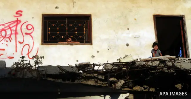 Palestinian children play inside their family destroyed house in Jabaliya refugee camp, in the northern Gaza Strip on 23 July 2011 house was destroyed during the Israeli assault on Gaza in late 2008 to early 2009, and be...