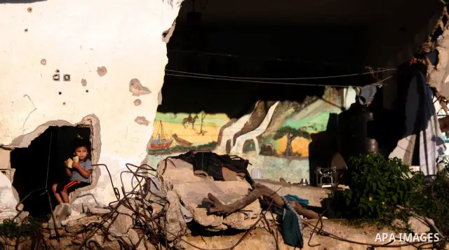 A Palestinian child plays inside her family destroyed house in Jabaliya refugee camp, in the northern Gaza Strip on 23 July 2011 house was destroyed during the Israeli assault on Gaza in late 2008 to early 2009, and beca...