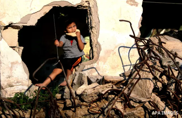 A Palestinian child plays inside her family destroyed house in Jabaliya refugee camp, in the northern Gaza Strip on 23 July 2011 house was destroyed during the Israeli assault on Gaza in late 2008 to early 2009, and beca...
