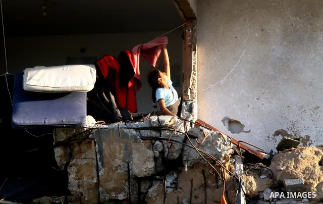A Palestinian child plays inside her family destroyed house in Jabaliya refugee camp, in the northern Gaza Strip on 23 July 2011 house was destroyed during the Israeli assault on Gaza in late 2008 to early 2009, and beca...
