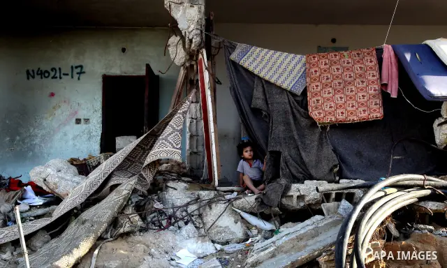 A Palestinian child plays inside her family destroyed house in Jabaliya refugee camp, in the northern Gaza Strip on 23 July 2011 house was destroyed during the Israeli assault on Gaza in late 2008 to early 2009, and beca...