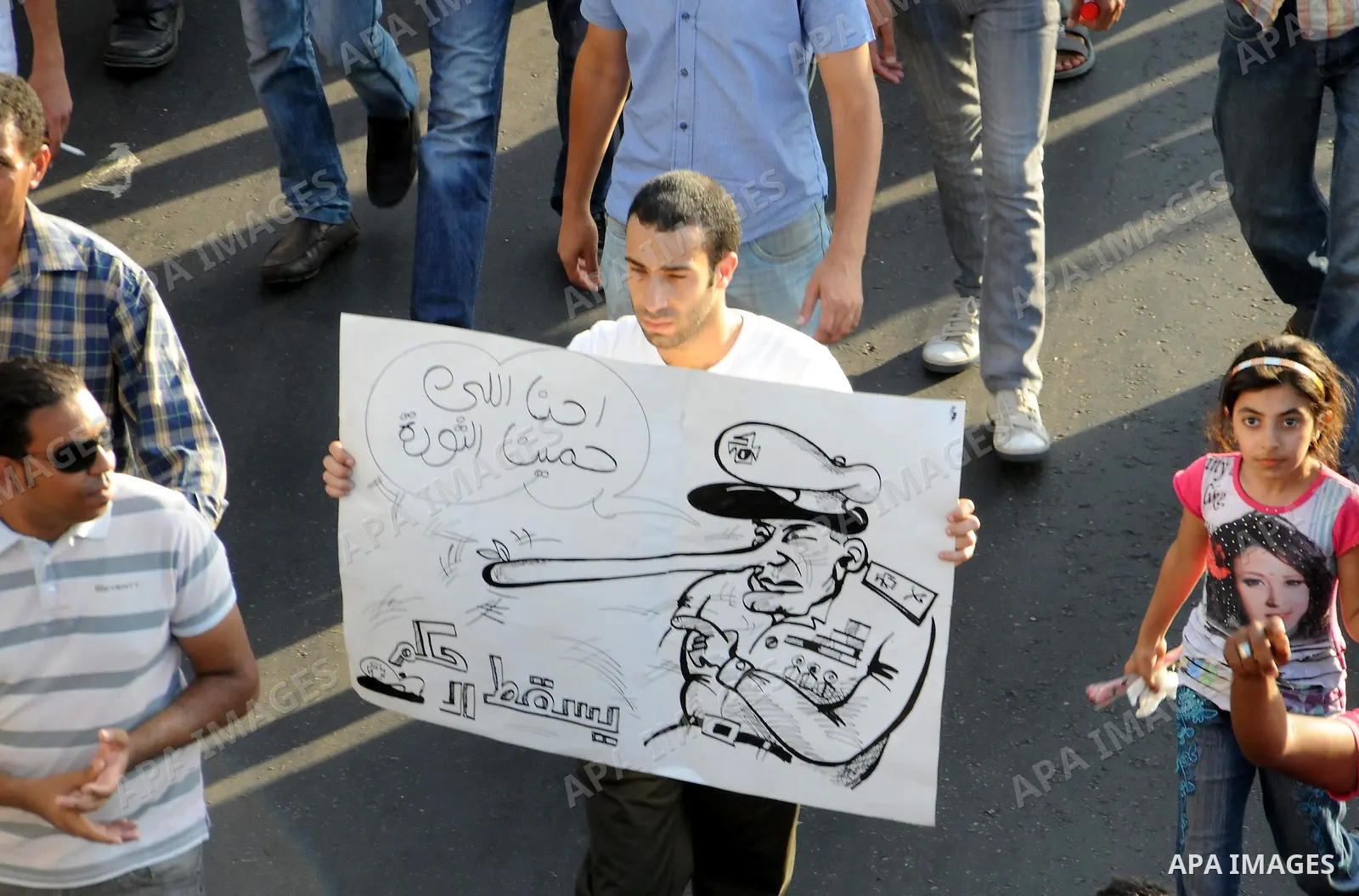 Egyptian protesters march towards the defence ministry, the headquarters of the Supreme Council of the Armed Forces, in Cairo on July 23, 2011 to show their anger at the ruling military's handling of the transition from...