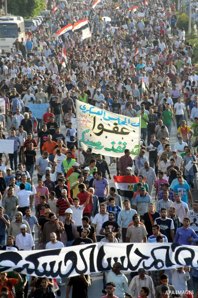 Egyptian protesters march towards the defence ministry, the headquarters of the Supreme Council of the Armed Forces, in Cairo on July 23, 2011 to show their anger at the ruling military's handling of the transition from...
