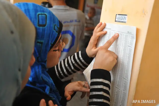 Palestinian secondary school students read a local newspaper to find their results in Gaza city on July 24,2011. The Ministry of Education in Gaza Strip and the West Bank announced the results together. Photo by Majdi Fa...