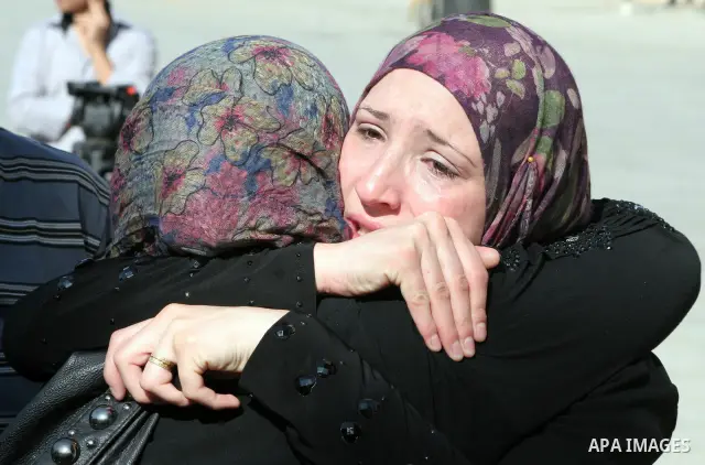 Palestinian relatives Hug their secondary school students after find their results in the West Bank city of Hebron on July 24, 2011.Photo by Najeh Hashlamoun