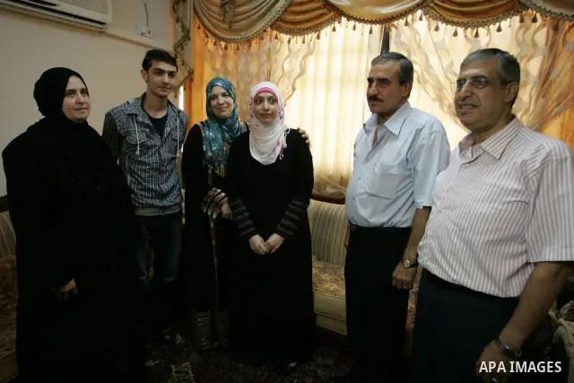 Hadeel Jamal Jaber, a Palestinian secondary school student and the winner of the fourth level in Palestine celebrates with her family in Gaza city on July 24, 2011. Photo by Abed Rahim Khatib