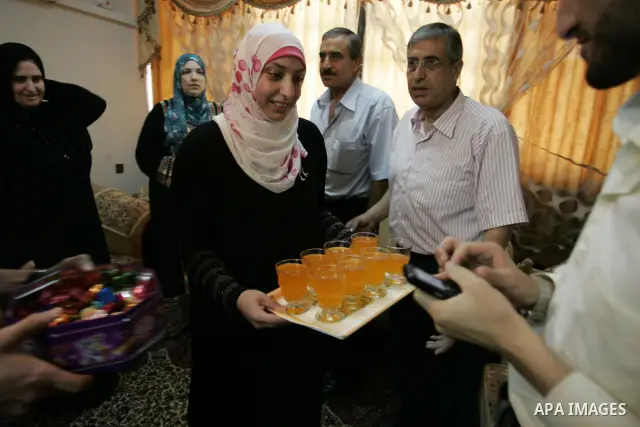 Hadeel Jamal Jaber, a Palestinian secondary school student and the winner of the fourth level in Palestine provides juice to her family in Gaza city on July 24, 2011. Photo by Abed Rahim Khatib
