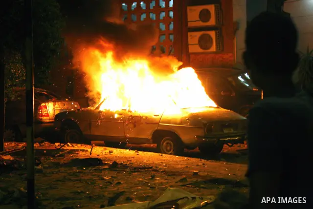 Demonstrators throw rocks during clashes with loyalists of the ruling military council in Abbasiya district, where the army blocked the road leading to the defence ministry, the headquarters of the Supreme Council of the...