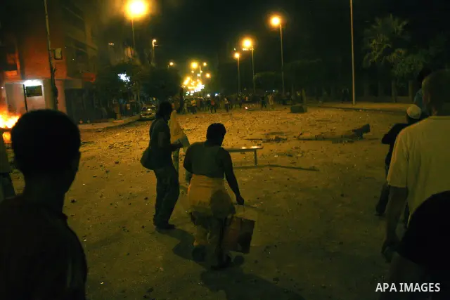 Demonstrators throw rocks during clashes with loyalists of the ruling military council in Abbasiya district, where the army blocked the road leading to the defence ministry, the headquarters of the Supreme Council of the...