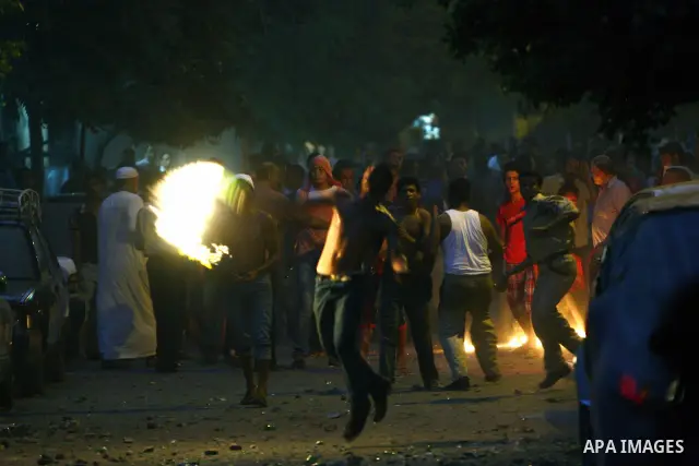 Demonstrators throw rocks during clashes with loyalists of the ruling military council in Abbasiya district, where the army blocked the road leading to the defence ministry, the headquarters of the Supreme Council of the...