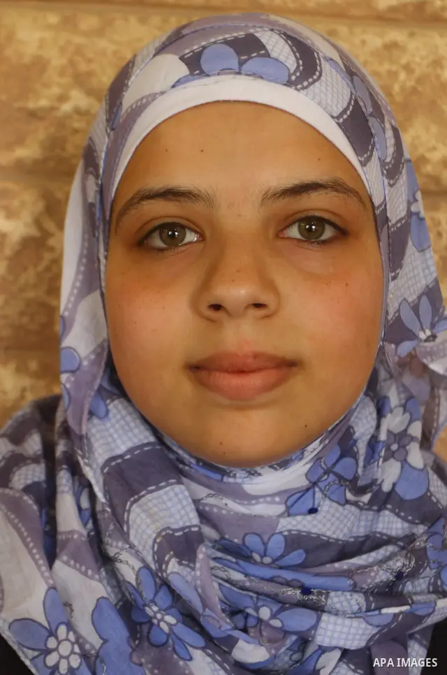 Maram Mostafa Salah, a Palestinian student in secondary school and winning first place in the Gaza Strip, celebrates with her family after she received their results of final high school exams in Gaza city on July 24, 20...