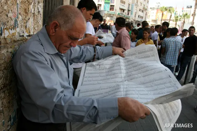 Palestinians look for their relatives' names in the results of final high school exams, known as "Tawjihi" in the West Bank city of Ramallah on July 24,2011. Photo by Issam Rimawi